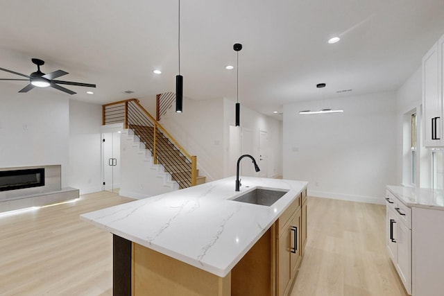 4519 Wahoo St, Dallas, TX 75210 - kitchen with a sink, light wood finished floors, a ceiling fan, a kitchen island with sink, and recessed lighting