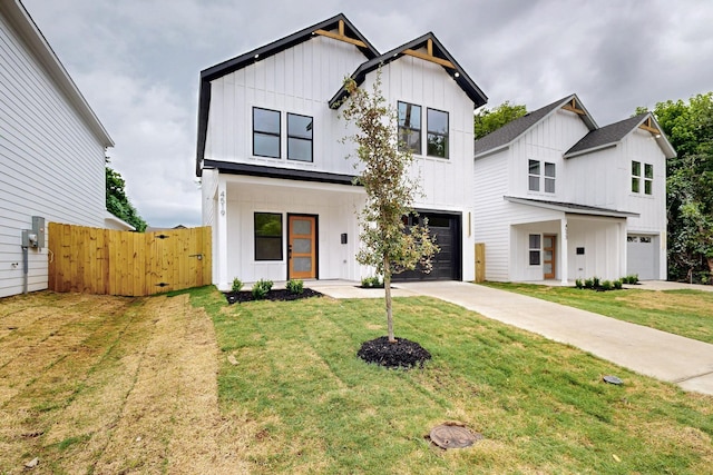 4519 Wahoo St, Dallas, TX 75210 - modern farmhouse with board and batten siding, a garage, concrete driveway, and a gate