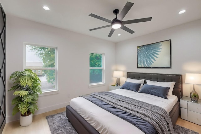 4519 Wahoo St, Dallas, TX 75210 - bedroom featuring multiple windows, light wood-style floors, recessed lighting, ceiling fan, and baseboards