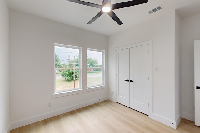 4519 Wahoo St, Dallas, TX 75210 - unfurnished bedroom with light wood-style floors, baseboards, a closet, and a ceiling fan