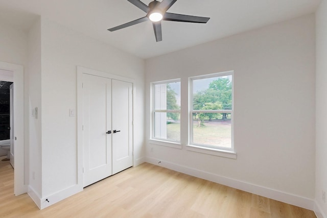 4519 Wahoo St, Dallas, TX 75210 - unfurnished bedroom with light wood-style flooring, baseboards, a closet, and a ceiling fan