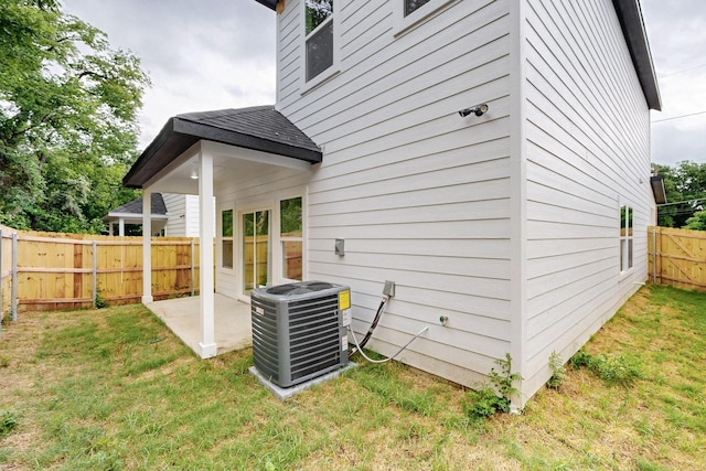 4519 Wahoo St, Dallas, TX 75210 - rear view of house with cooling unit, a patio, and a shingled roof