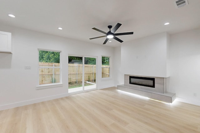 4519 Wahoo St, Dallas, TX 75210 - unfurnished living room featuring light wood-style flooring, a fireplace, recessed lighting, and ceiling fan