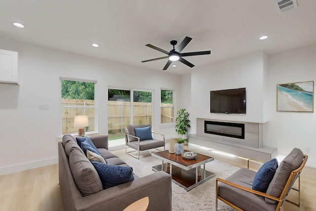 4519 Wahoo St, Dallas, TX 75210 - living area featuring light wood-style floors, recessed lighting, ceiling fan, a fireplace, and baseboards