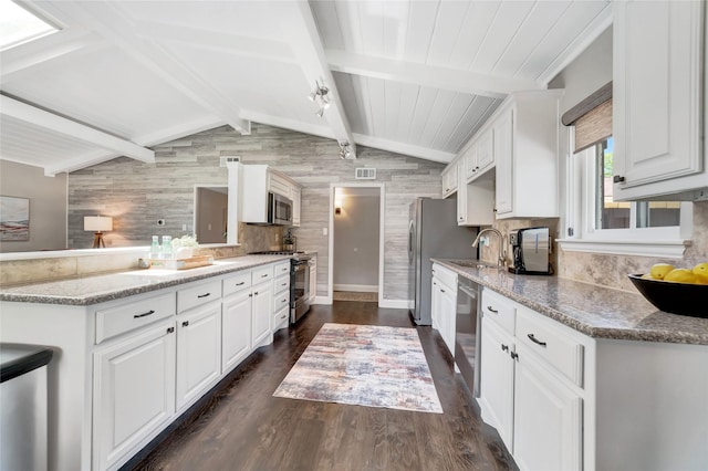 746 Greenhaven Dr, Richardson, TX 75080 - kitchen featuring appliances with stainless steel finishes, white cabinetry, dark wood-style floors, and wooden walls