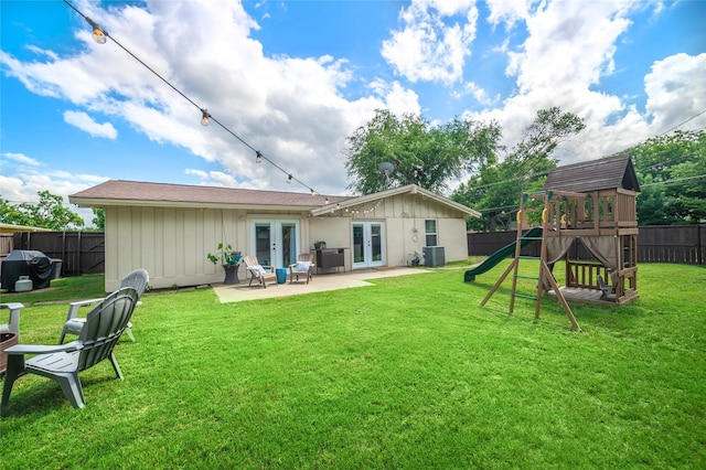 746 Greenhaven Dr, Richardson, TX 75080 - back of house with french doors, central air condition unit, a playground, a patio, and board and batten siding