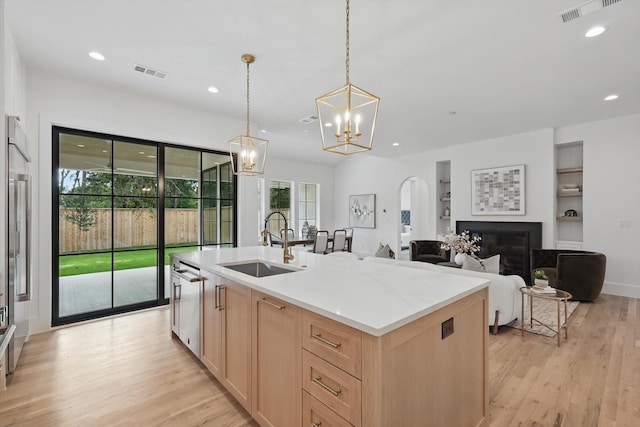 6607 Kenwell St, Dallas, TX 75209 - kitchen featuring a sink, light brown cabinetry, stainless steel dishwasher, light wood finished floors, and recessed lighting