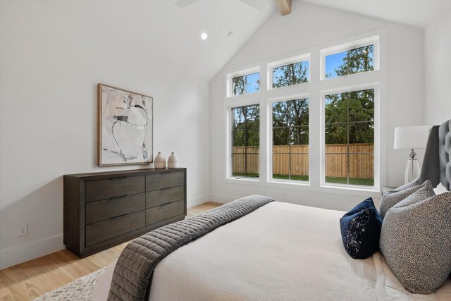 6607 Kenwell St, Dallas, TX 75209 - bedroom with light wood-type flooring, beam ceiling, baseboards, and high vaulted ceiling