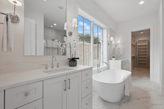 6607 Kenwell St, Dallas, TX 75209 - full bath featuring vanity, marble finish flooring, recessed lighting, a walk in closet, and a freestanding tub