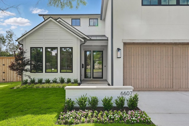 6607 Kenwell St, Dallas, TX 75209 - view of front of home with a front yard, stucco siding, and an attached garage