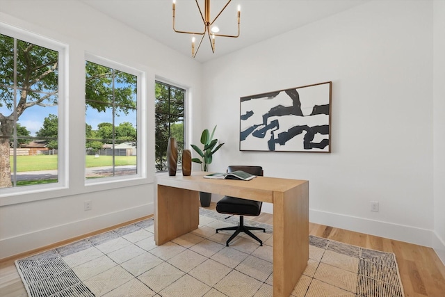 6607 Kenwell St, Dallas, TX 75209 - office area featuring baseboards, a chandelier, and light wood-style flooring