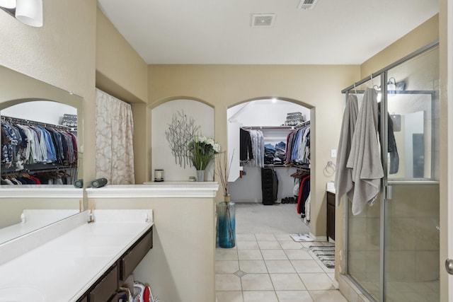 5400 Ivyridge Ln, Mckinney, TX 75071 - full bath with vanity, a walk in closet, a shower stall, and tile patterned floors