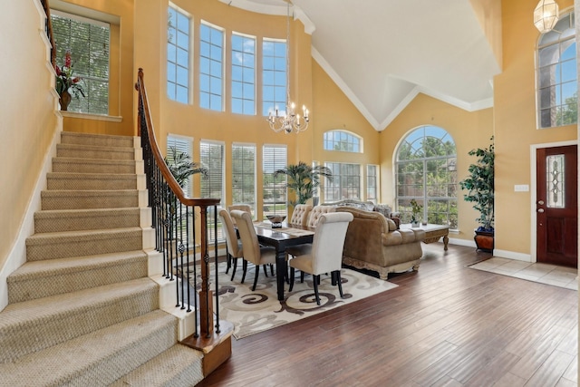 5400 Ivyridge Ln, Mckinney, TX 75071 - foyer entrance featuring high vaulted ceiling, stairs, a chandelier, baseboards, and crown molding