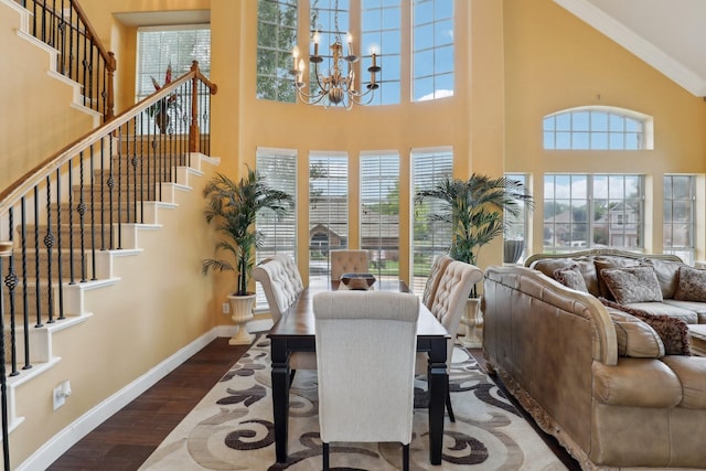 5400 Ivyridge Ln, Mckinney, TX 75071 - dining room featuring a high ceiling, a chandelier, wood finished floors, baseboards, and stairway
