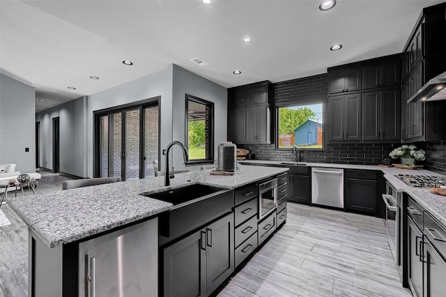 58 Lone Oak Blvd, Pottsboro, TX 75076 - kitchen with a sink, appliances with stainless steel finishes, light stone counters, tasteful backsplash, and recessed lighting