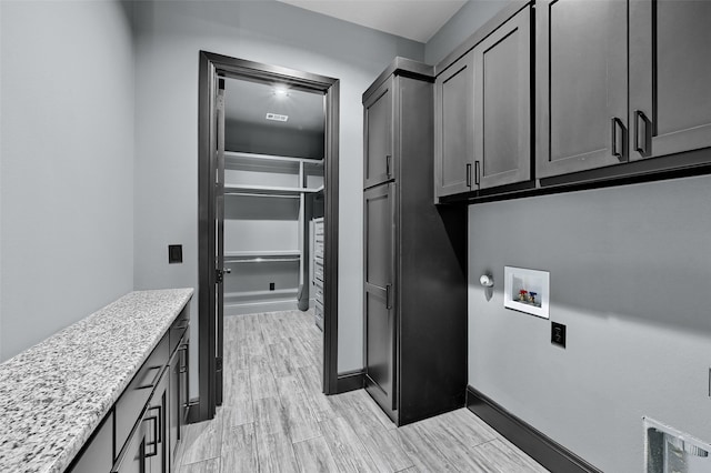 58 Lone Oak Blvd, Pottsboro, TX 75076 - laundry room featuring cabinet space, hookup for a washing machine, light wood finished floors, and baseboards