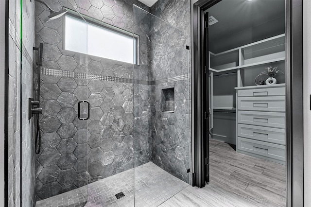 58 Lone Oak Blvd, Pottsboro, TX 75076 - full bathroom with a shower stall, wood finished floors, and a walk in closet