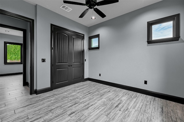 58 Lone Oak Blvd, Pottsboro, TX 75076 - unfurnished bedroom with baseboards, light wood finished floors, a closet, and a ceiling fan