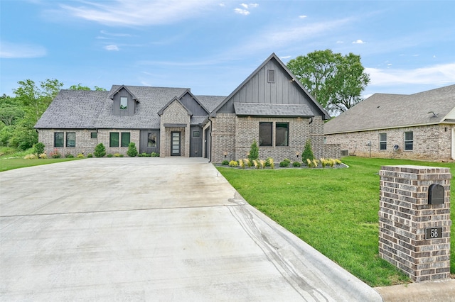 58 Lone Oak Blvd, Pottsboro, TX 75076 - view of front of house featuring board and batten siding, brick siding, concrete driveway, and a front lawn