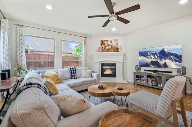 7812 Rockledge Dr, Mckinney, TX 75071 - living area featuring a ceiling fan, wood finished floors, a glass covered fireplace, recessed lighting, and baseboards