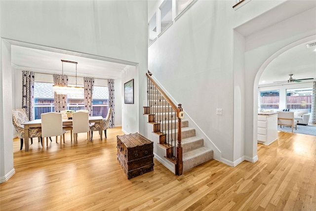 7812 Rockledge Dr, Mckinney, TX 75071 - staircase featuring wood finished floors, plenty of natural light, arched walkways, and a high ceiling