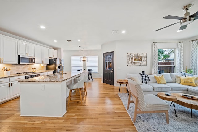 7812 Rockledge Dr, Mckinney, TX 75071 - kitchen featuring appliances with stainless steel finishes, light wood-style flooring, healthy amount of natural light, and recessed lighting