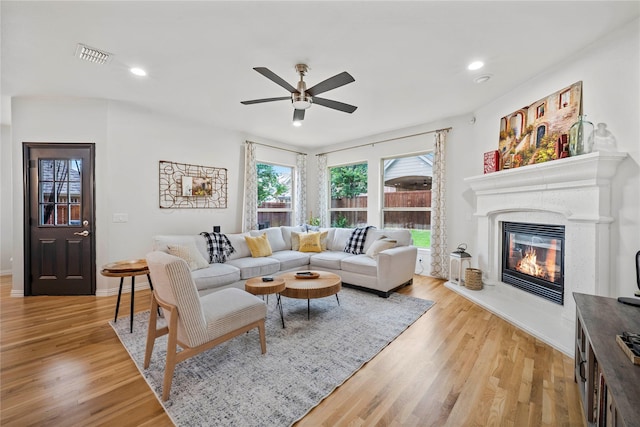 7812 Rockledge Dr, Mckinney, TX 75071 - living room with a ceiling fan, light wood-style flooring, a glass covered fireplace, baseboards, and recessed lighting