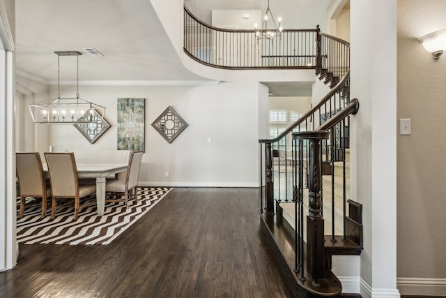 18261 Brighton Grn, Dallas, TX 75252 - entrance foyer featuring a chandelier, wood finished floors, stairway, crown molding, and baseboards