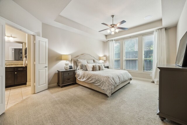 18261 Brighton Grn, Dallas, TX 75252 - bedroom with a tray ceiling, baseboards, light carpet, and ensuite bathroom