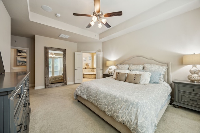 18261 Brighton Grn, Dallas, TX 75252 - bedroom featuring light colored carpet, a raised ceiling, baseboards, ensuite bathroom, and a ceiling fan