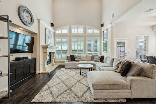 18261 Brighton Grn, Dallas, TX 75252 - living room with dark wood-style floors, a high ceiling, and a fireplace