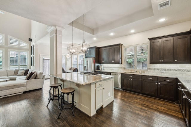 18261 Brighton Grn, Dallas, TX 75252 - kitchen with a sink, appliances with stainless steel finishes, open floor plan, dark brown cabinetry, and recessed lighting
