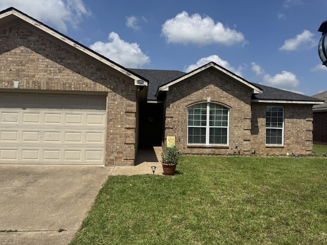 440 Maggie Cir, Flint, TX 75762 - ranch-style house featuring brick siding, a front yard, a shingled roof, driveway, and a garage