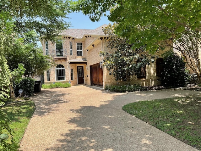 5704 El Campo Ave, Fort Worth, TX 76107 - view of front facade featuring brick siding, a balcony, concrete driveway, and a garage