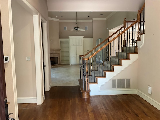5704 El Campo Ave, Fort Worth, TX 76107 - stairs with baseboards, ceiling fan, crown molding, wood finished floors, and a fireplace