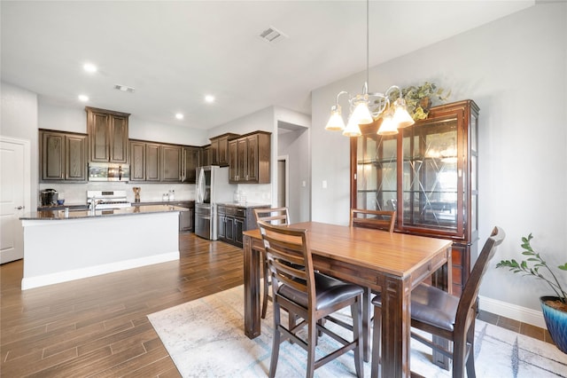 7524 Wispy Willow Ln, Little Elm, TX 76227 - dining area with a chandelier, dark wood-style flooring, baseboards, and recessed lighting