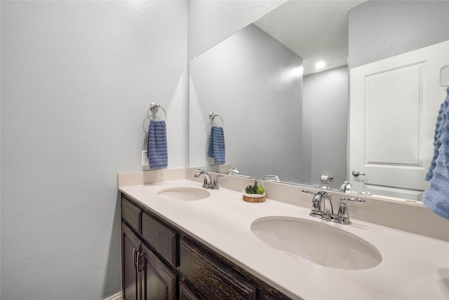 7524 Wispy Willow Ln, Little Elm, TX 76227 - full bathroom featuring a textured wall and double vanity