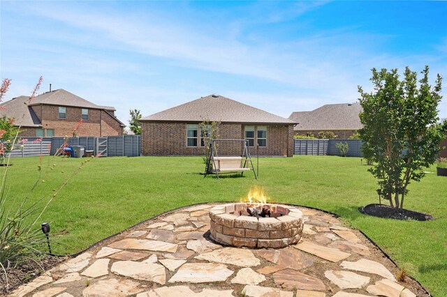 7524 Wispy Willow Ln, Little Elm, TX 76227 - rear view of property with a fire pit and brick siding