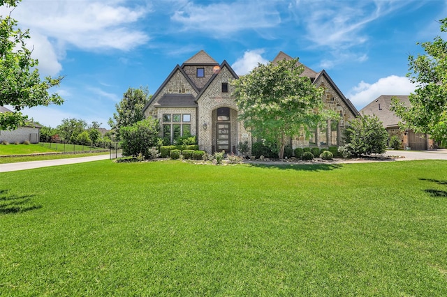512 Maggie Trl, Allen, TX 75002 - english style home featuring brick siding, stone siding, and a front yard