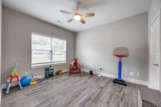 205 W Travis St, Howe, TX 75459 - playroom with wood finished floors, a ceiling fan, and baseboards