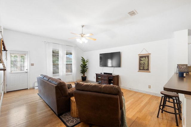 1042 Grimes Dr, Forney, TX 75126 - living room featuring ceiling fan, lofted ceiling, light wood-type flooring, and baseboards