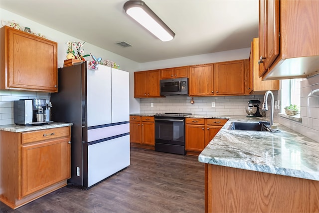 2036 Shawnee Trl, Fort Worth, TX 76247 - kitchen with stainless steel microwave, black range, freestanding refrigerator, a sink, and dark wood finished floors