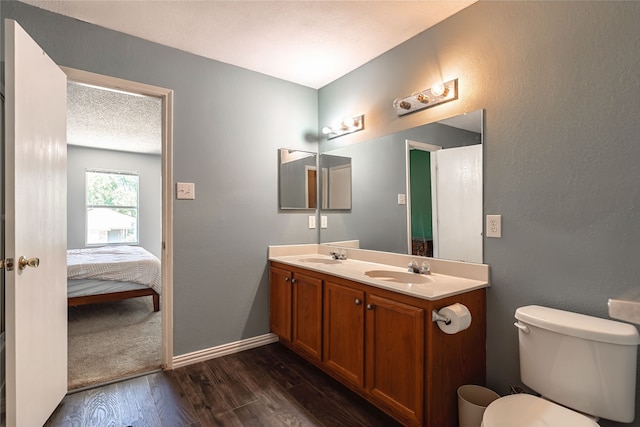2036 Shawnee Trl, Fort Worth, TX 76247 - bathroom featuring double vanity, wood finished floors, toilet, ensuite bath, and baseboards