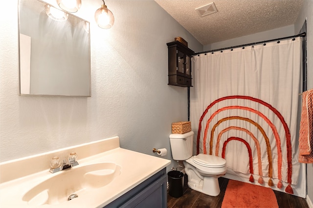 2036 Shawnee Trl, Fort Worth, TX 76247 - full bathroom with vanity, a textured ceiling, wood finished floors, toilet, and a textured wall