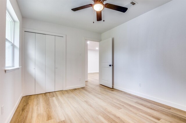 626 Thrush Ave, Duncanville, TX 75116 - unfurnished bedroom with wood finished floors, baseboards, a closet, and a ceiling fan