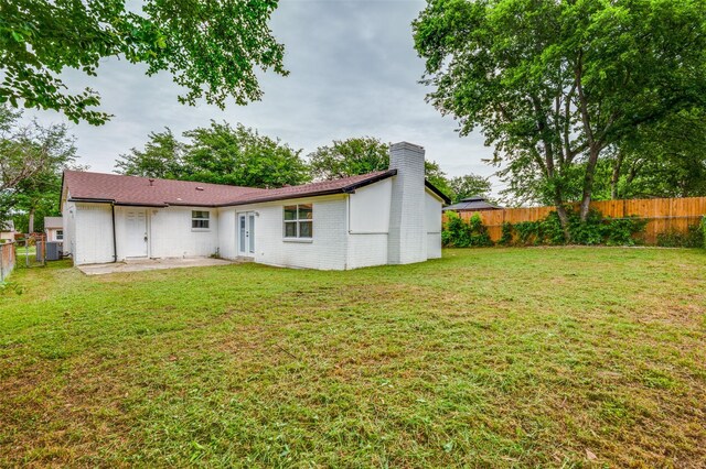 626 Thrush Ave, Duncanville, TX 75116 - back of house with a chimney, a patio, central AC unit, and brick siding