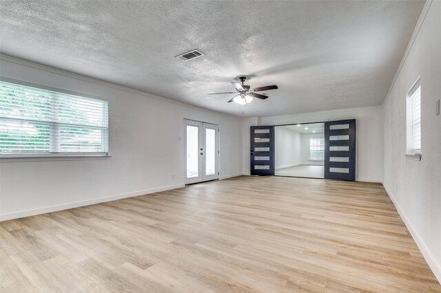 626 Thrush Ave, Duncanville, TX 75116 - spare room featuring a textured ceiling, a ceiling fan, light wood-type flooring, baseboards, and french doors