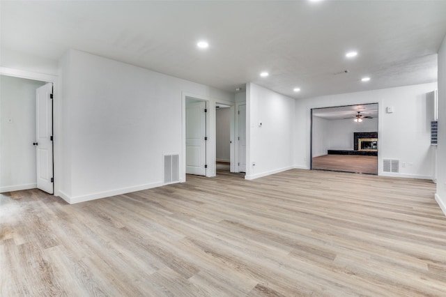 626 Thrush Ave, Duncanville, TX 75116 - unfurnished living room featuring recessed lighting, light wood-style floors, baseboards, and a fireplace with raised hearth
