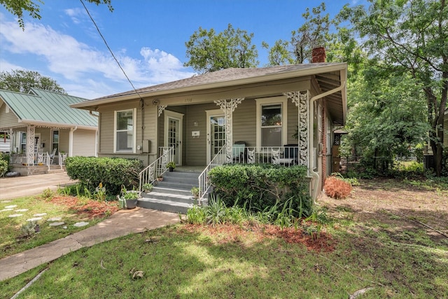 1710 Mckenzie Ave, Waco, TX 76708 - bungalow-style home with a porch and a chimney