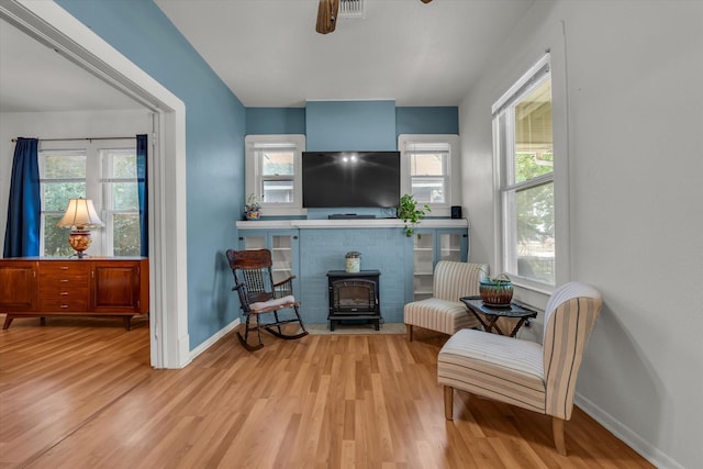 1710 Mckenzie Ave, Waco, TX 76708 - living area with a wood stove, wood finished floors, baseboards, and plenty of natural light